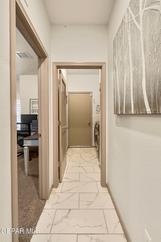 corridor with independent washer and dryer