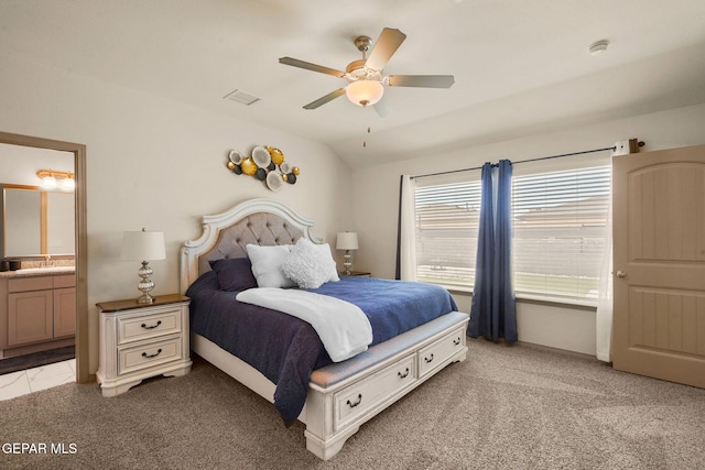 carpeted bedroom featuring sink, ensuite bath, vaulted ceiling, and ceiling fan