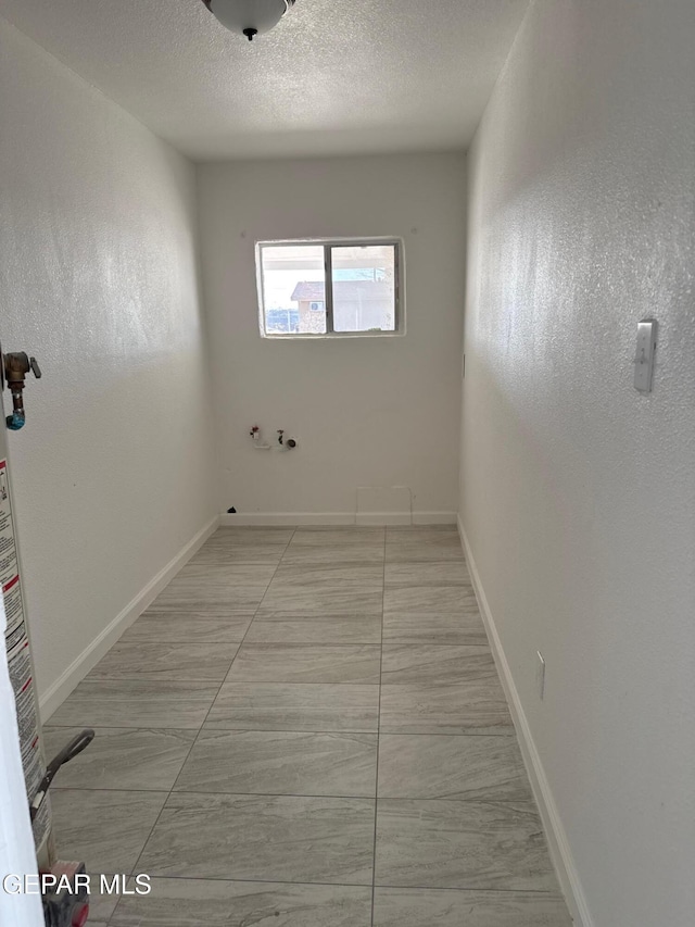 empty room with a textured ceiling