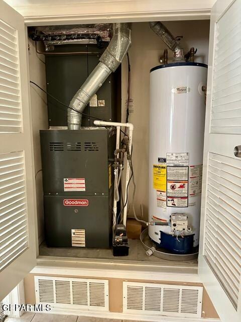 utility room featuring gas water heater and heating unit