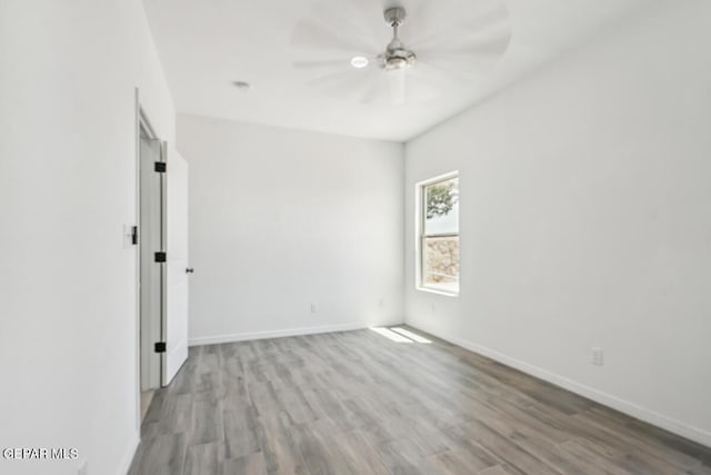 spare room featuring hardwood / wood-style flooring and ceiling fan