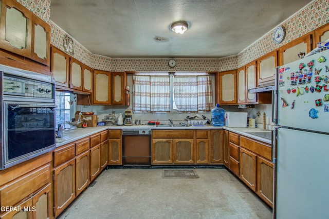 kitchen with sink, black appliances, and a textured ceiling