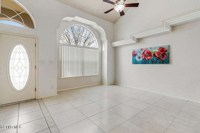 tiled foyer entrance with lofted ceiling, plenty of natural light, and ceiling fan