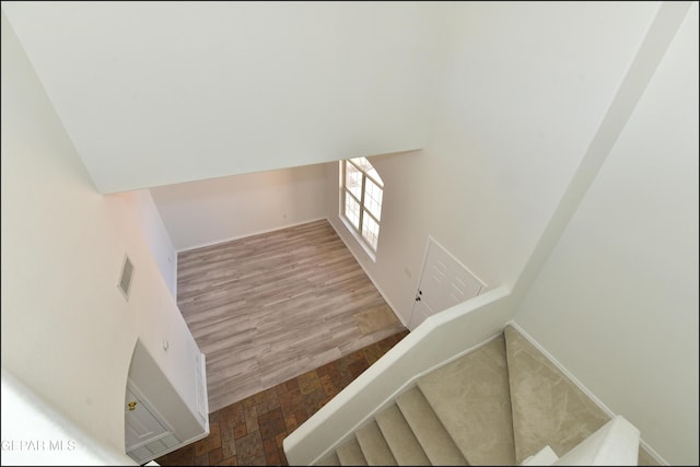 stairway featuring wood-type flooring