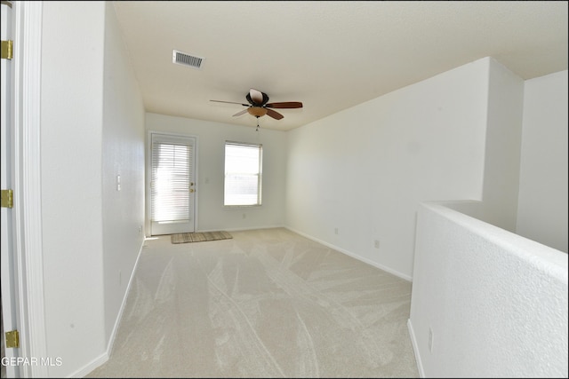 carpeted spare room with ceiling fan