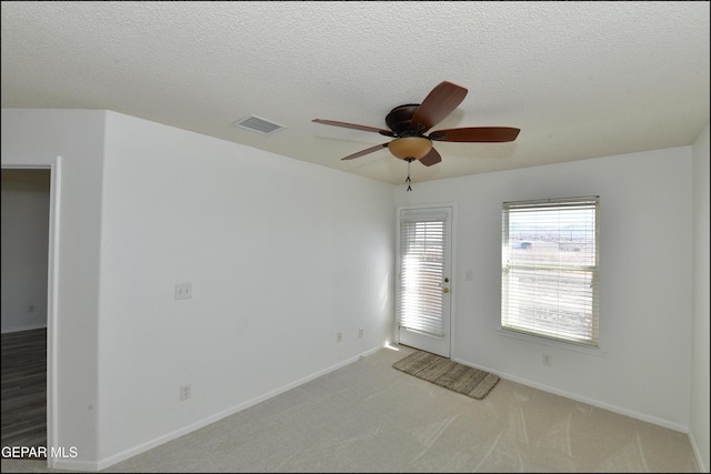 interior space featuring ceiling fan and a textured ceiling