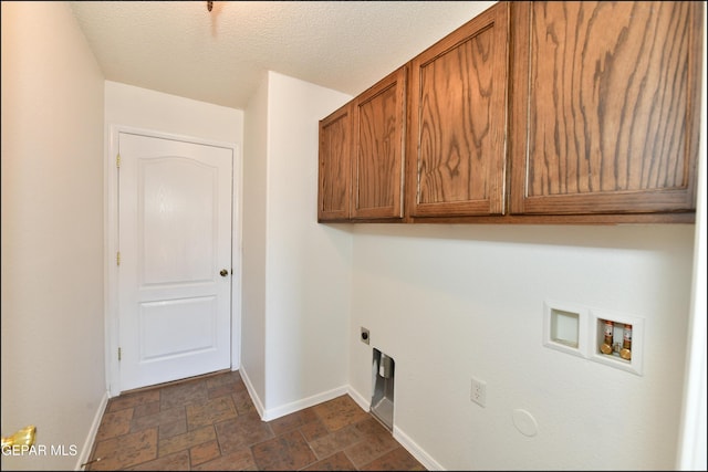 laundry room featuring washer hookup, electric dryer hookup, cabinets, and a textured ceiling