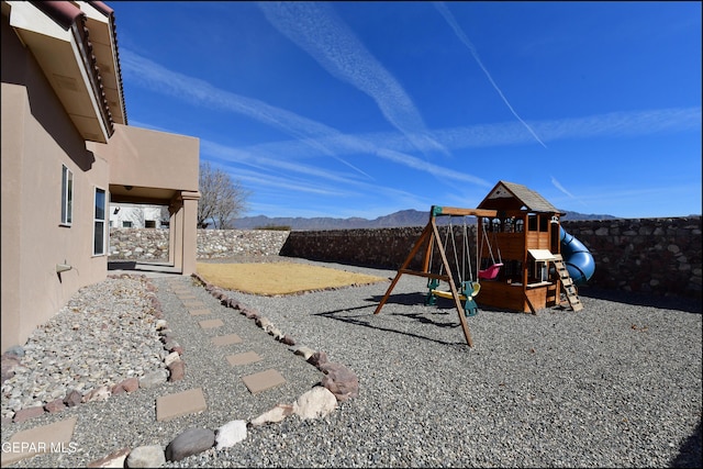 view of jungle gym featuring a mountain view