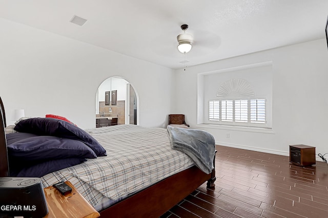 bedroom with dark hardwood / wood-style floors and ceiling fan