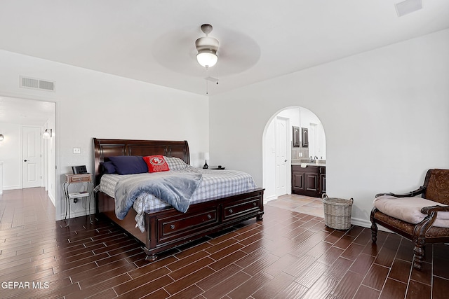 bedroom featuring sink, ceiling fan, and ensuite bathroom