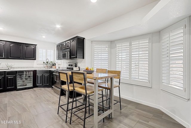 kitchen featuring appliances with stainless steel finishes and beverage cooler