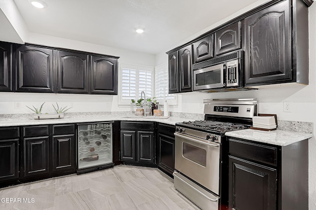 kitchen featuring stainless steel appliances and beverage cooler