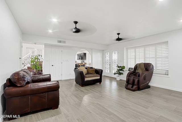 living room featuring french doors and ceiling fan