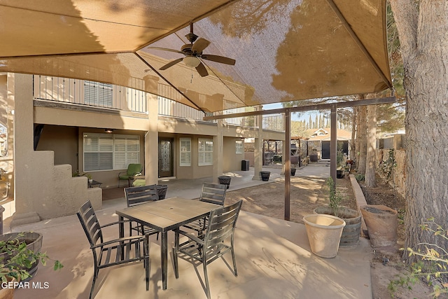 view of patio / terrace with a balcony and ceiling fan