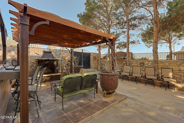 view of patio / terrace featuring exterior fireplace and a pergola