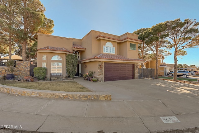 mediterranean / spanish-style house with a garage