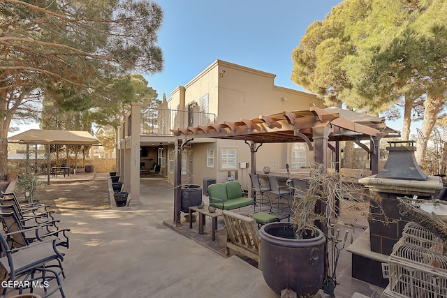 view of patio / terrace with an outdoor bar and a pergola