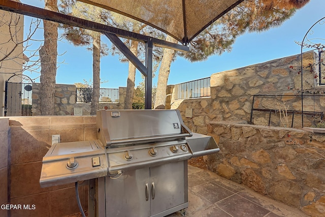 view of patio with exterior kitchen and grilling area