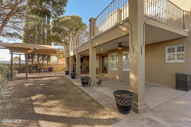 exterior space featuring ceiling fan and a balcony