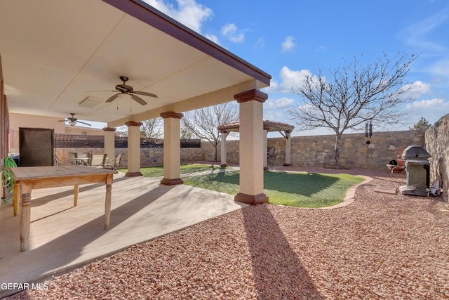 view of yard featuring a patio area and ceiling fan