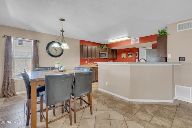 dining space featuring a textured ceiling