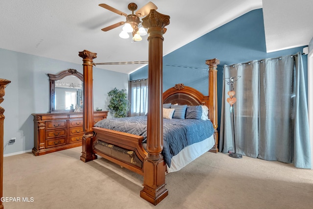 bedroom featuring lofted ceiling, a textured ceiling, light colored carpet, and ceiling fan