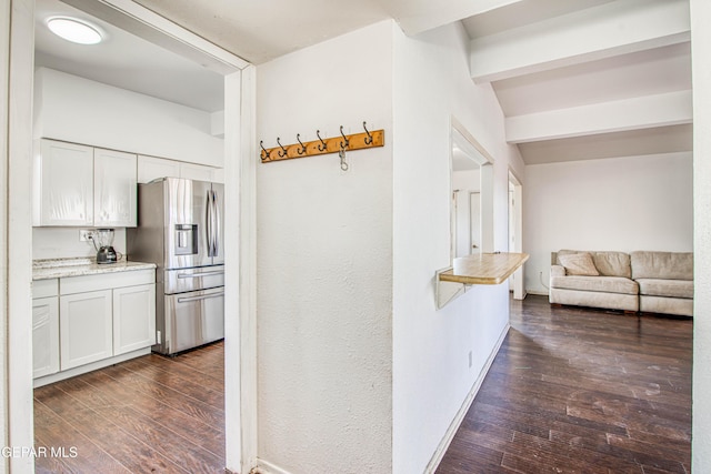 corridor with lofted ceiling with beams and dark hardwood / wood-style flooring