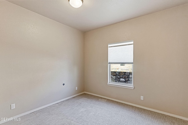 unfurnished room featuring light carpet