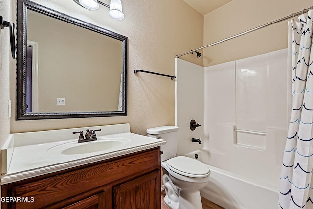 full bathroom with vanity, shower / bath combination with curtain, and toilet