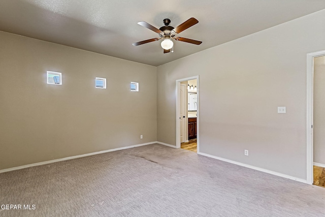 carpeted empty room featuring ceiling fan