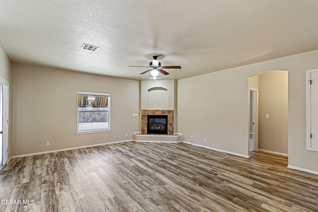 unfurnished living room featuring hardwood / wood-style floors, a textured ceiling, and ceiling fan