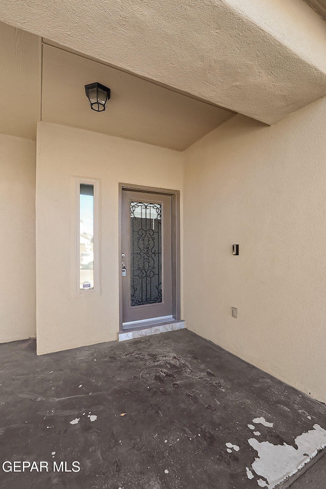 doorway to property with a patio area