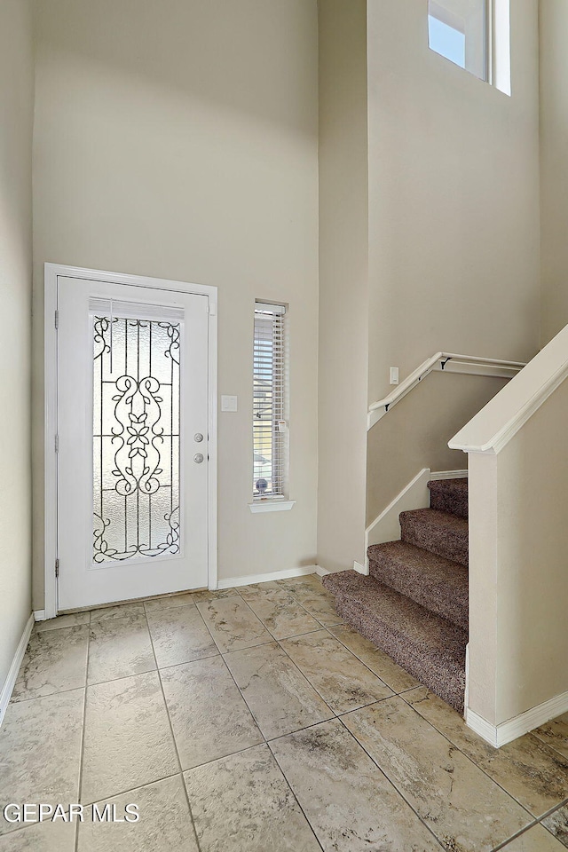 entryway with a towering ceiling