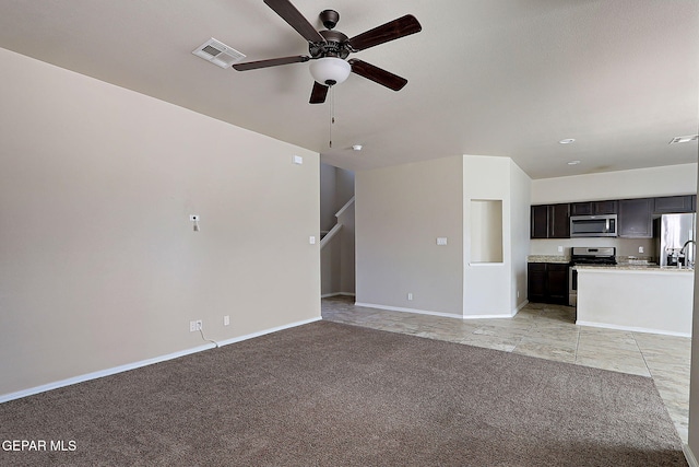 unfurnished living room with light carpet and ceiling fan