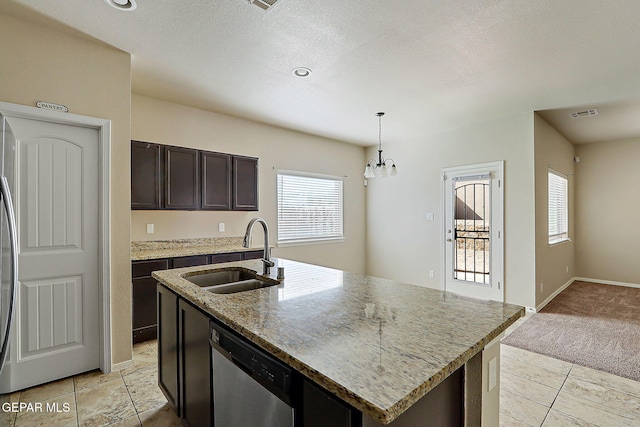 kitchen featuring sink, dishwasher, hanging light fixtures, dark brown cabinets, and an island with sink