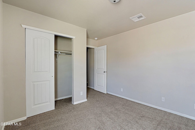 unfurnished bedroom featuring a closet and carpet