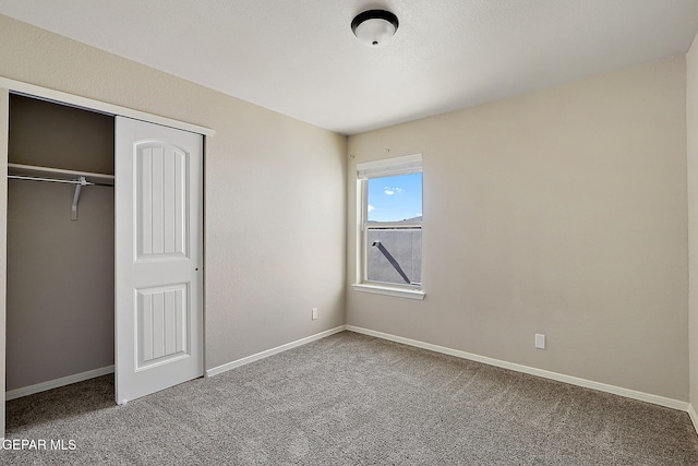 unfurnished bedroom with carpet floors and a closet