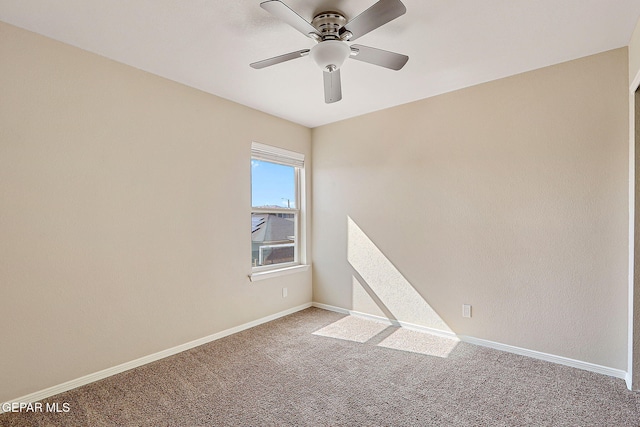 empty room with carpet flooring and ceiling fan