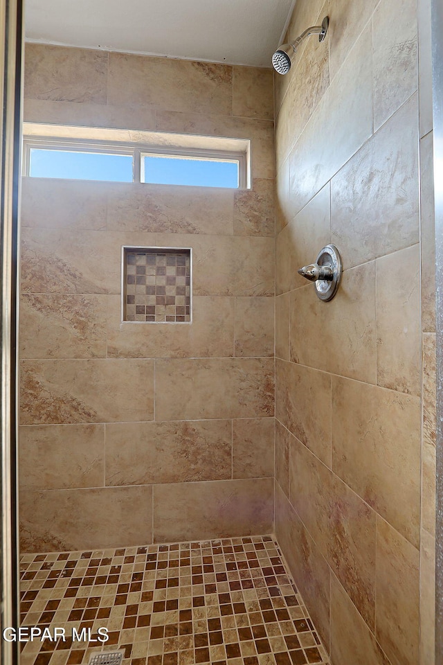 bathroom featuring tiled shower