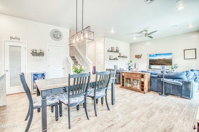 dining space with ceiling fan and light hardwood / wood-style floors