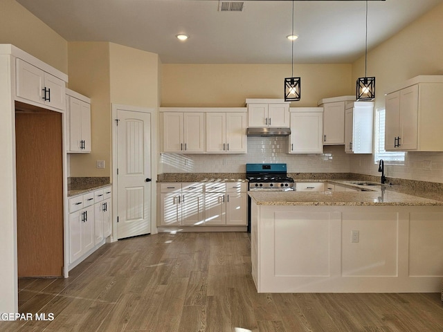 kitchen featuring pendant lighting, sink, range, white cabinetry, and wood-type flooring