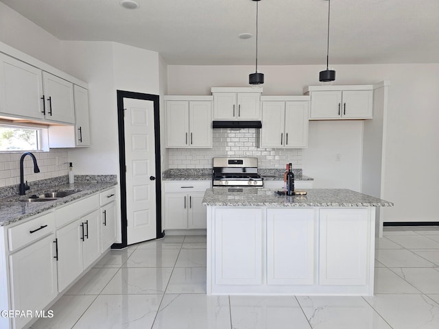 kitchen with stainless steel range oven, sink, white cabinetry, hanging light fixtures, and a kitchen island