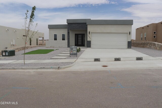 220 Emerald Brass, Horizon City, TX 79928 - view of front of home featuring driveway, an attached garage, and stucco siding