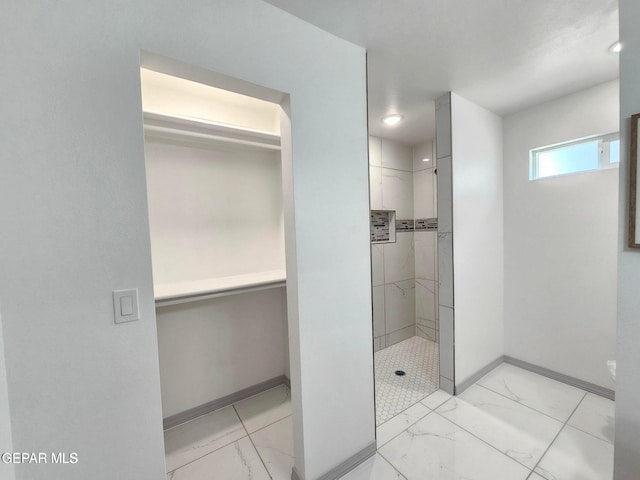 bathroom with tiled shower