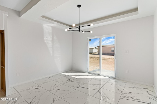 interior space featuring marble finish floor, baseboards, a tray ceiling, and a notable chandelier