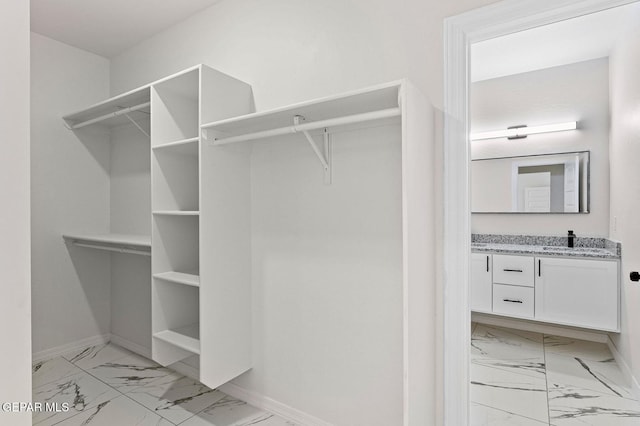 spacious closet featuring marble finish floor