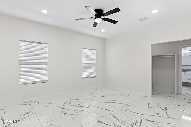 unfurnished bedroom featuring marble finish floor, recessed lighting, a closet, visible vents, and baseboards