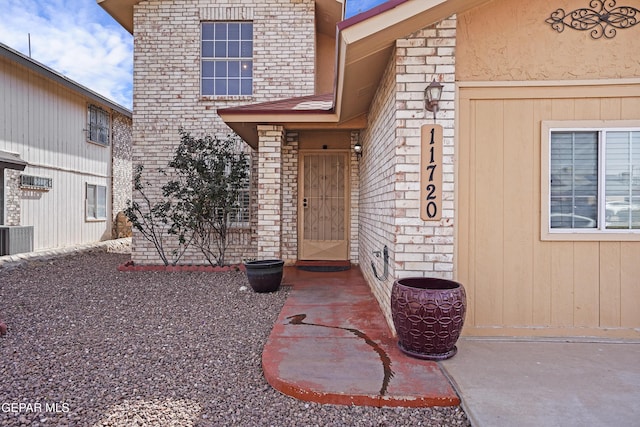 entrance to property featuring cooling unit