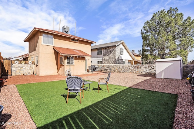 rear view of property featuring central AC, a storage unit, a patio area, and a lawn