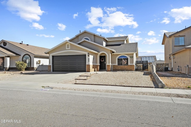 view of front of home featuring a garage and central AC